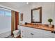 Traditional bathroom with decorative framed mirror, tile countertop and tub with shower at 3978 Lemonwood Dr, Sarasota, FL 34232