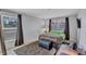 Comfortable bedroom with ample natural light, neutral decor, and dark curtains at 3978 Lemonwood Dr, Sarasota, FL 34232