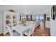 Dining area with bright light fixture, terracotta tile floor and view of living room at 3978 Lemonwood Dr, Sarasota, FL 34232