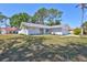 Single story house with a well manicured lawn and mature trees at 3978 Lemonwood Dr, Sarasota, FL 34232
