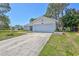 Single story house with an attached two car garage, well manicured lawn and mature trees at 3978 Lemonwood Dr, Sarasota, FL 34232