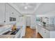 Bright kitchen with granite countertops, terracotta tile floors, and white appliances at 3978 Lemonwood Dr, Sarasota, FL 34232