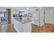 Well-lit kitchen with white cabinetry, an island with granite countertop, and modern appliances at 3978 Lemonwood Dr, Sarasota, FL 34232