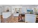 Bright living room featuring Saltillo tile, large white sofa, and decorative furnishings near dining area at 3978 Lemonwood Dr, Sarasota, FL 34232