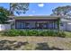 Large screened in patio with comfortable seating and views of the backyard at 3978 Lemonwood Dr, Sarasota, FL 34232