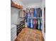 Organized walk-in closet featuring ample hanging space, shelving, shoe rack, and neutral tile flooring for efficient storage at 3978 Lemonwood Dr, Sarasota, FL 34232