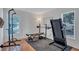 Home workout room with weight bench, treadmill, and natural light from two windows at 3978 Lemonwood Dr, Sarasota, FL 34232