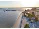 Expansive waterfront aerial shot showcasing the beautiful beach, boardwalk, pier, and surrounding community at 4405 Harbor Blvd, Port Charlotte, FL 33952