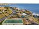Beautiful aerial view of community amenities, including a tennis court, basketball court, playground, and beach access at 4405 Harbor Blvd, Port Charlotte, FL 33952