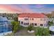Backyard view with an enclosed patio, well-maintained lawn, and lush greenery at 4405 Harbor Blvd, Port Charlotte, FL 33952