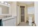Neutral bathroom features a marble vanity top, walk in shower, and a large mirror at 4405 Harbor Blvd, Port Charlotte, FL 33952