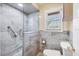 Modern bathroom featuring tiled walk-in shower with glass door and window at 4405 Harbor Blvd, Port Charlotte, FL 33952