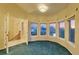 Bedroom featuring large windows with water views and an open door to a hallway with stairs at 4405 Harbor Blvd, Port Charlotte, FL 33952