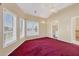 Bedroom featuring vaulted ceilings, plush carpet, and an en suite bathroom with amazing natural light at 4405 Harbor Blvd, Port Charlotte, FL 33952