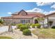 Two-story home with a tile roof, manicured landscaping, and a well-maintained lawn at 4405 Harbor Blvd, Port Charlotte, FL 33952