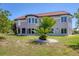 Expansive two-story home with a beige exterior, terracotta roof, and lush green landscaping at 4405 Harbor Blvd, Port Charlotte, FL 33952