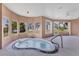 Indoor hot tub with surrounding windows offering outdoor views, enhancing relaxation and privacy at 4405 Harbor Blvd, Port Charlotte, FL 33952