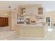 Spacious kitchen with custom cabinets, stainless steel appliances, a large island, and tile flooring at 4405 Harbor Blvd, Port Charlotte, FL 33952