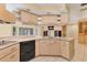 Well-lit kitchen featuring ample cabinet space, a cooktop, and a breakfast bar for casual dining at 4405 Harbor Blvd, Port Charlotte, FL 33952