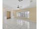 Bright living space with tile flooring, fan, built-in bookshelves, and a large bay window at 4405 Harbor Blvd, Port Charlotte, FL 33952