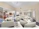 Large living room featuring comfortable white sofas, modern decor, and plenty of natural light at 4405 Harbor Blvd, Port Charlotte, FL 33952