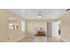 Spacious living room with tile floors, ceiling fan, and sliding doors to an outdoor space at 4405 Harbor Blvd, Port Charlotte, FL 33952