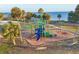A view of the community playground, featuring colorful play structures and a safe, cushioned surface at 4405 Harbor Blvd, Port Charlotte, FL 33952