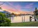 Picturesque waterfront view showcasing a canal, private boat docks, and beautiful sunset at 4405 Harbor Blvd, Port Charlotte, FL 33952