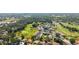 An aerial view shows the community's golf course, pool, and surrounding trees at 4580 Longwater # 61, Sarasota, FL 34235