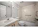 Bathroom with a white sink, a toilet, and tiled shower and tub with handrails at 4580 Longwater # 61, Sarasota, FL 34235