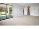 Bedroom featuring sliding glass door access to a screened-in patio at 4580 Longwater # 61, Sarasota, FL 34235