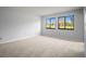 Bright bedroom with neutral walls and carpet features large windows offering ample natural light at 4580 Longwater # 61, Sarasota, FL 34235