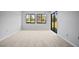 Spacious bedroom with neutral walls and carpet features large windows and sliding glass doors at 4580 Longwater # 61, Sarasota, FL 34235
