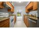 Efficient kitchen features granite counters, wood cabinets, and stainless steel appliances at 4580 Longwater # 61, Sarasota, FL 34235