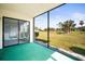 A screened-in lanai with a view of a green lawn and trees at 4580 Longwater # 61, Sarasota, FL 34235
