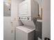 This laundry room shows a stacked washer and dryer with a water heater at 4580 Longwater # 61, Sarasota, FL 34235
