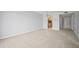Spacious living room with neutral tones, carpet flooring, and kitchen access at 4580 Longwater # 61, Sarasota, FL 34235