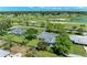 A single-level home with large manicured lawns and mature trees is located close to a golf course at 4611 17Th W Ave, Bradenton, FL 34209