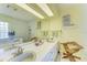 Spacious bathroom with double sinks, soaking tub, decorative chair, and ample natural light at 4611 17Th W Ave, Bradenton, FL 34209