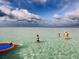 Shallow beach view featuring a Gathering wading in the water on a sunny day at 4611 17Th W Ave, Bradenton, FL 34209