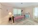 Cozy bedroom featuring a daybed with floral accents, complemented by soft colors and natural light at 4611 17Th W Ave, Bradenton, FL 34209