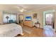 Bedroom with hardwood floors and a doorway leading to the bathroom at 4611 17Th W Ave, Bradenton, FL 34209