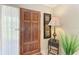 The front door is a solid wood door with carved designs and a black handle next to a table lamp at 4611 17Th W Ave, Bradenton, FL 34209