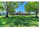 Beautiful single-story home with lush green lawn and mature trees providing shade at 4611 17Th W Ave, Bradenton, FL 34209
