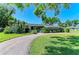 Charming single-story home featuring a well-manicured lawn and a circular driveway at 4611 17Th W Ave, Bradenton, FL 34209