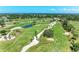 Stunning aerial view of the golf course with strategic sand traps, beautiful ponds, and expertly manicured greens at 4611 17Th W Ave, Bradenton, FL 34209