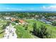 Aerial image of the golf course and club house with tennis courts surrounded by lush landscaping and a sunny sky at 4611 17Th W Ave, Bradenton, FL 34209