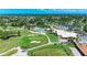 Aerial view of golf course with pool, clubhouse, putting green, and lush landscaping at 4611 17Th W Ave, Bradenton, FL 34209