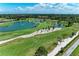 Expansive aerial view of a lush green golf course with water features and mature landscaping on a sunny day at 4611 17Th W Ave, Bradenton, FL 34209