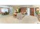 Spacious carpeted living room offers a view of the dining room with solid wood furniture and crown molding at 4611 17Th W Ave, Bradenton, FL 34209